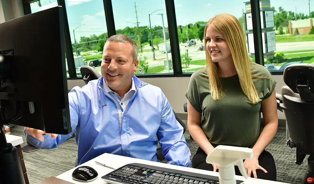 patient smiling and sitting right next to doctor